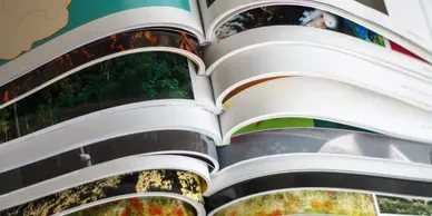 Stacked open brochures.