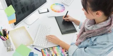 A designer working on a drawing tablet.
